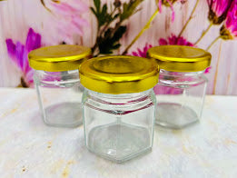 Envase de vidrio hexagonal con tapa metálica